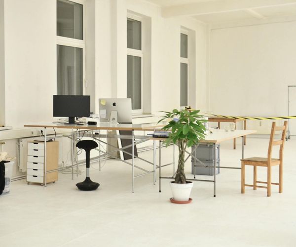 Bright and airy yoga studio with mats on the floor and large windows.